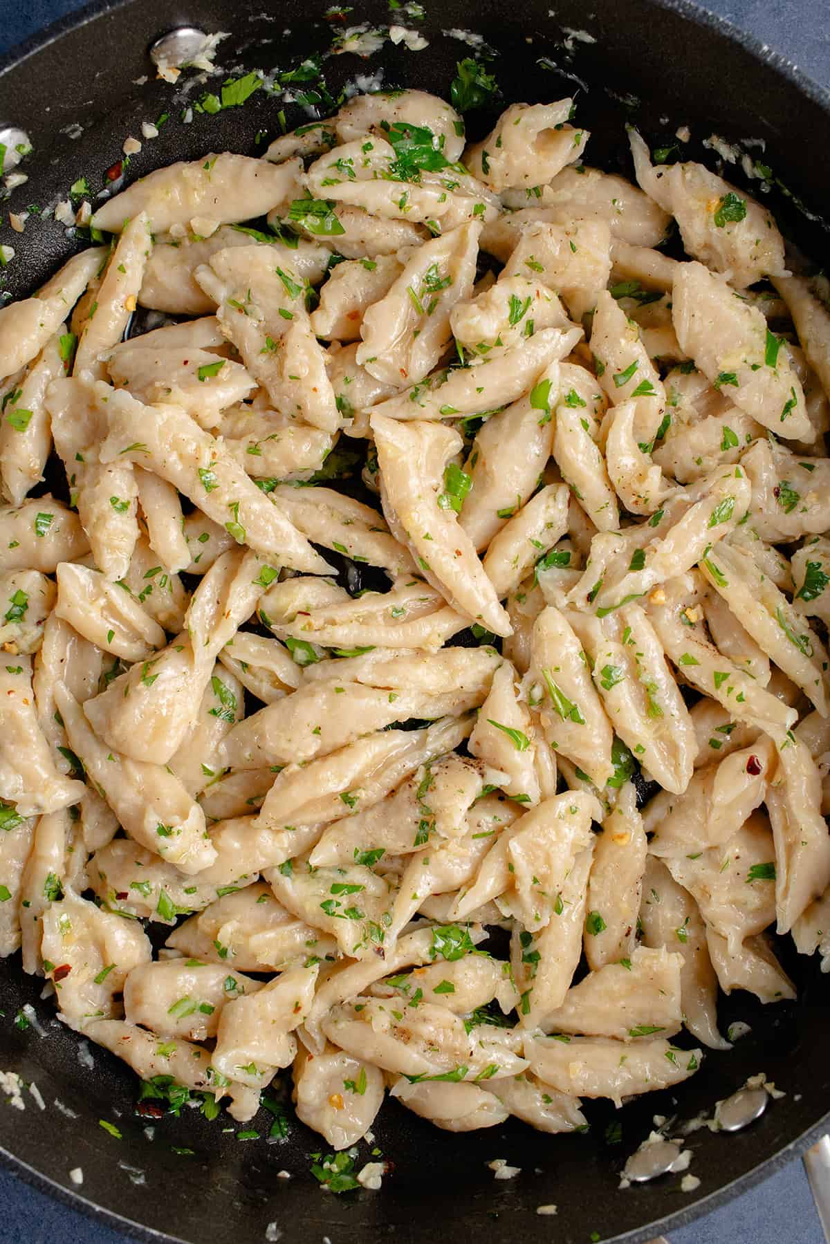 3-Ingredient Tofu Pasta in pan with garlic, olive, oil, and herbs