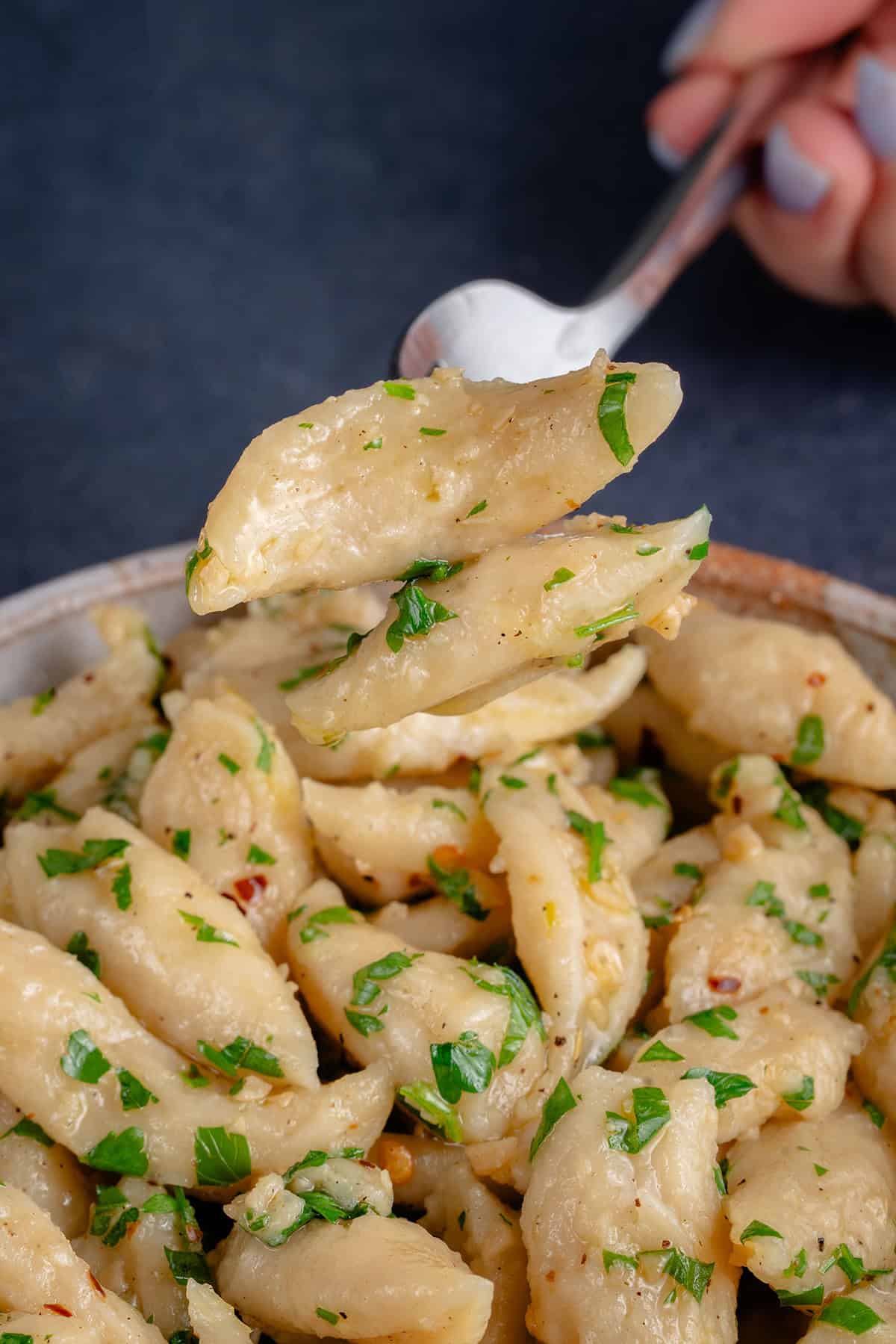 3-Ingredient Tofu Pasta in bowl being lifted with a fork