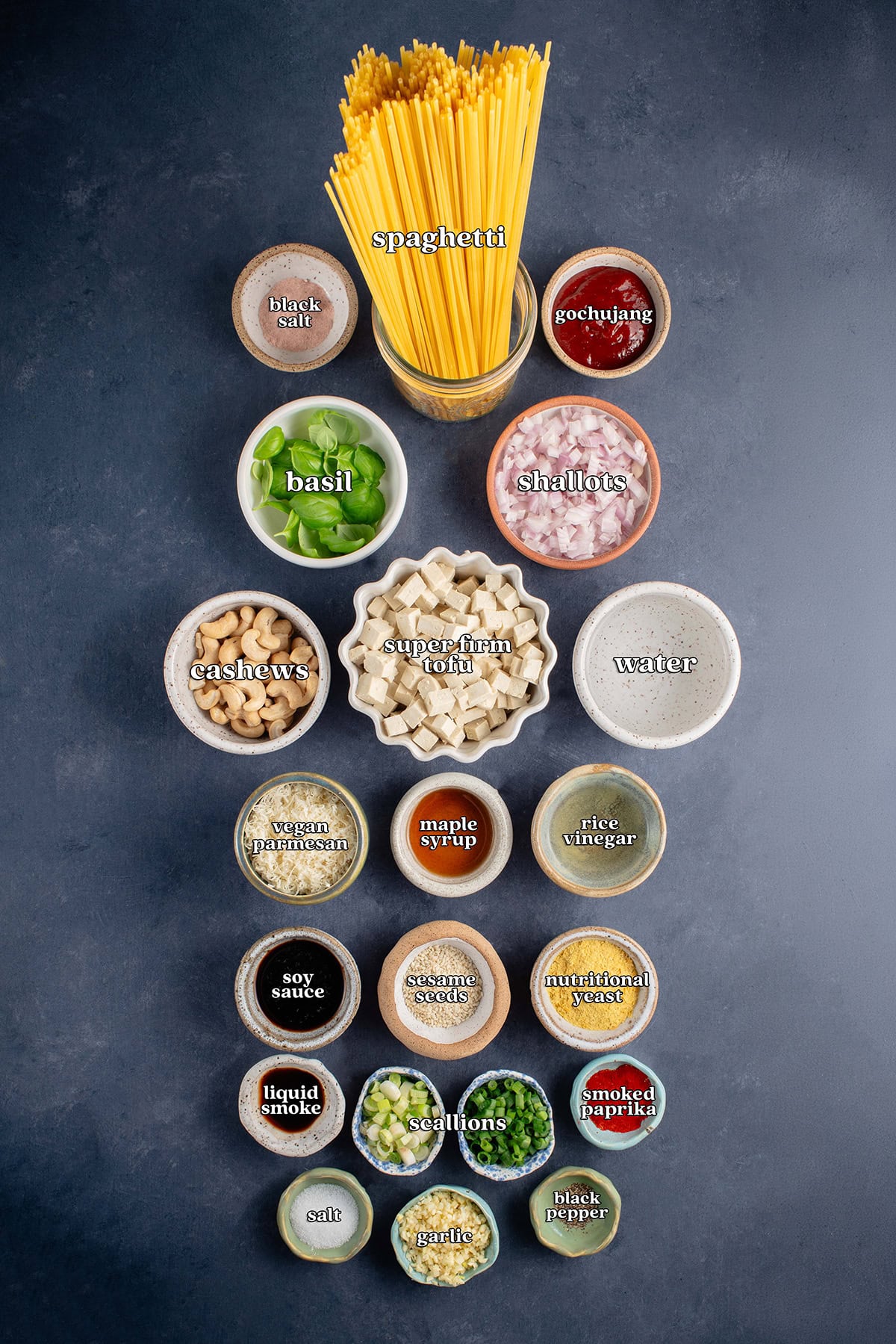 black salt, spaghetti, gochujang, basil, shallots, cashews, super firm tofu, water, vegan parmesan, maple syrup, rice vinegar, soy sauce, sesame seeds, nutritional yeast, liquid smoke, scallions, smoked paprika, salt, garlic, black pepper