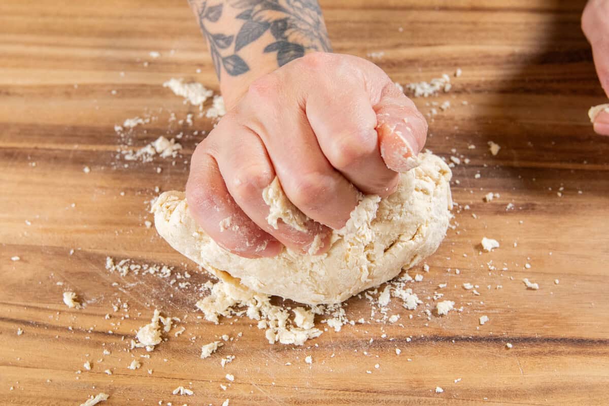 kneading the pasta dough on a wooden surface