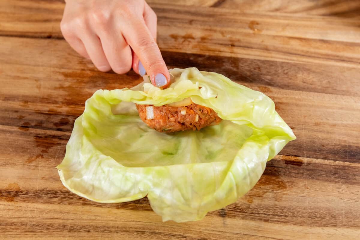 cabbage being rolled over filling