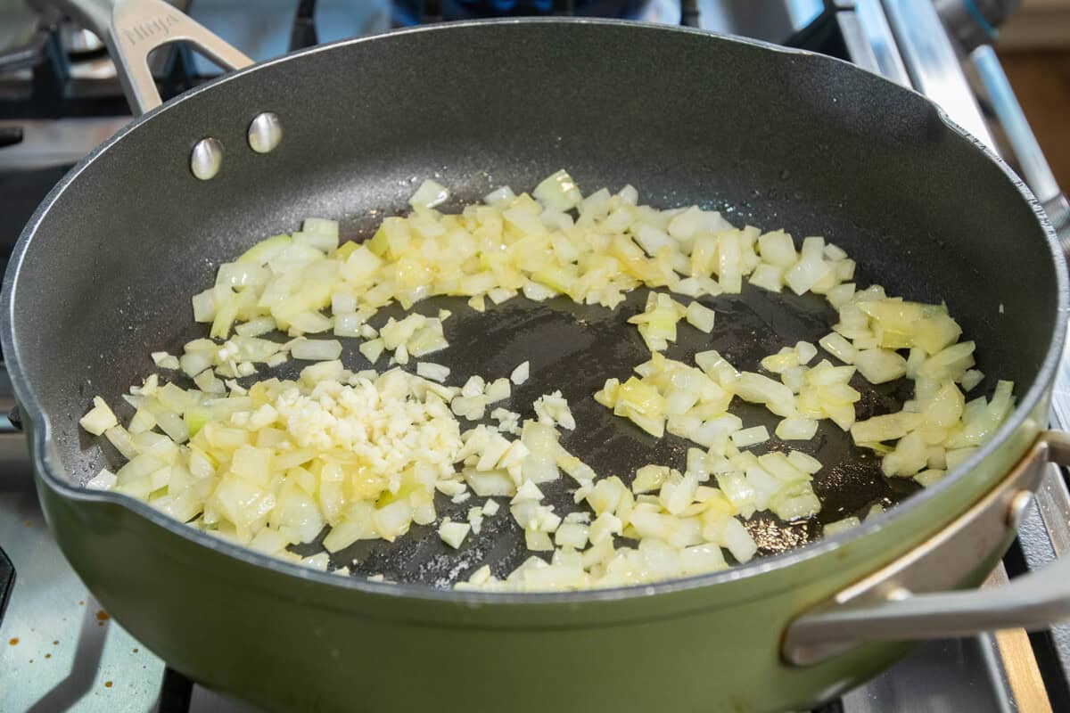 onions and garlic cooking in skillet