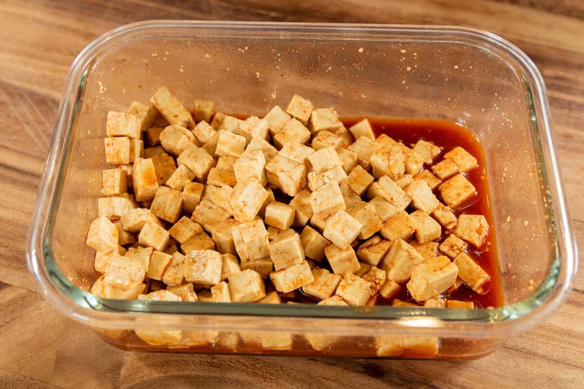 marinated tofu cubes in a glass dish