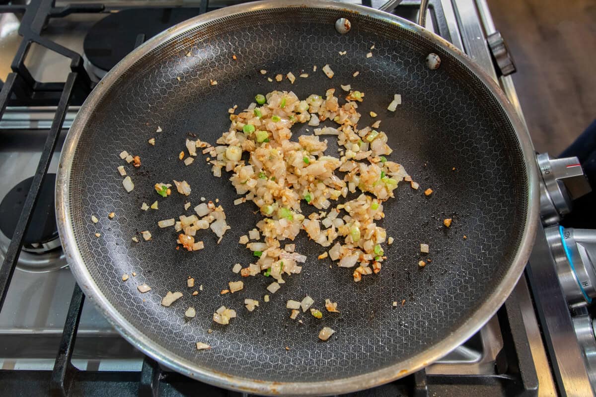sautéed garlic, green onions, and shallots in a pan