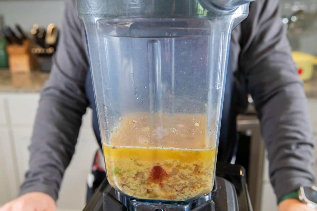 adding sauce ingredients to a blender before blending