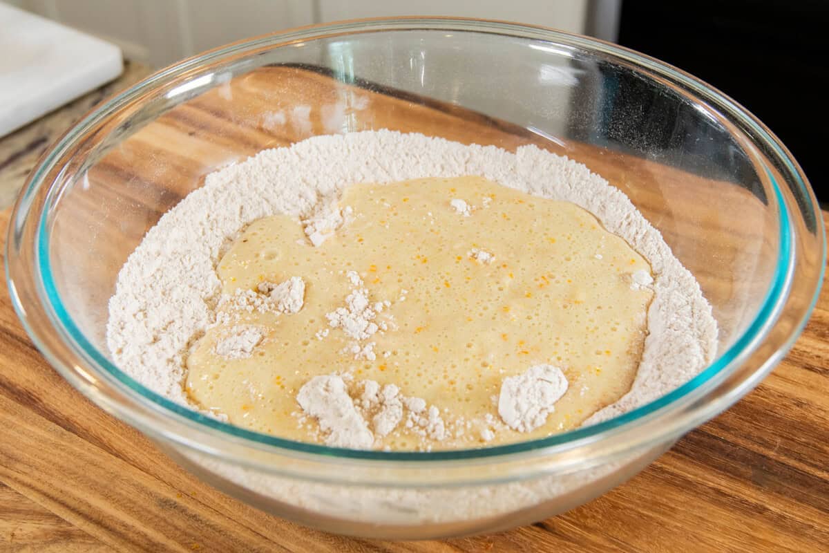 adding the wet ingredients to the dry ingredients in large bowl