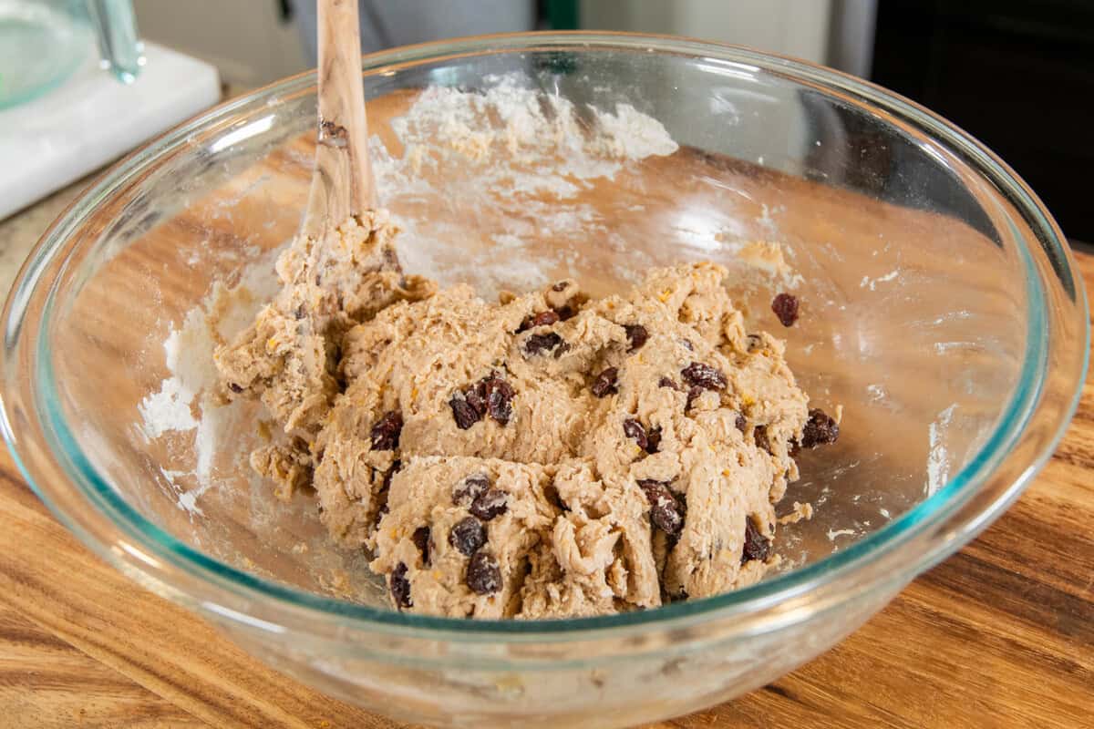 shaggy dough in a large bowl with wooden spoon