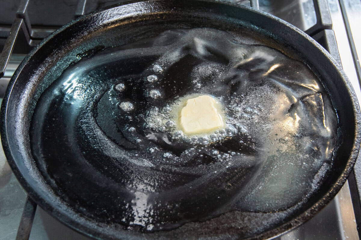 melting butter onto a cast iron skillet