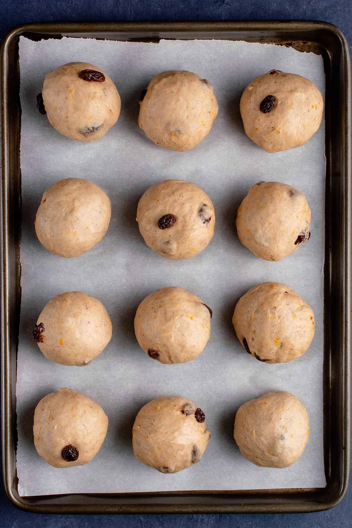 unbaked vegan hot cross buns on baking sheet before second rise