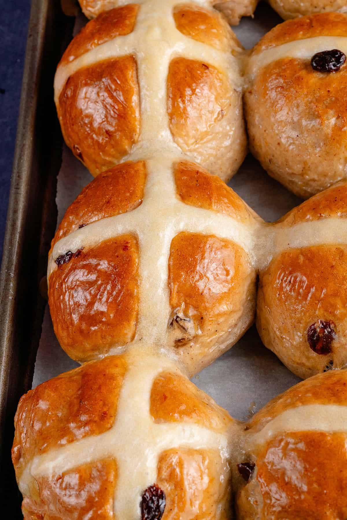 baked vegan hot cross buns on a baking sheet