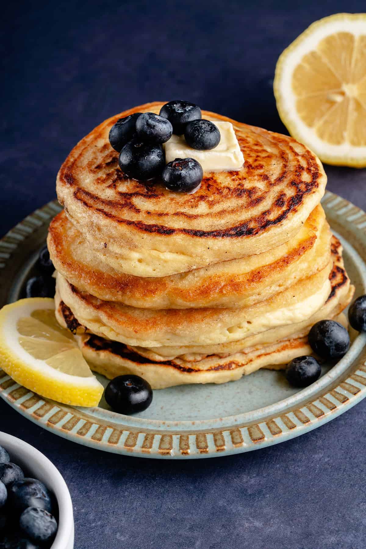 vegan lemon ricotta pancakes on a plate with fruit