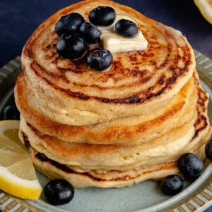 vegan lemon ricotta pancakes on a plate with fruit