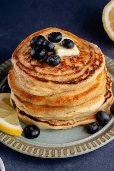 vegan lemon ricotta pancakes on a plate with fruit