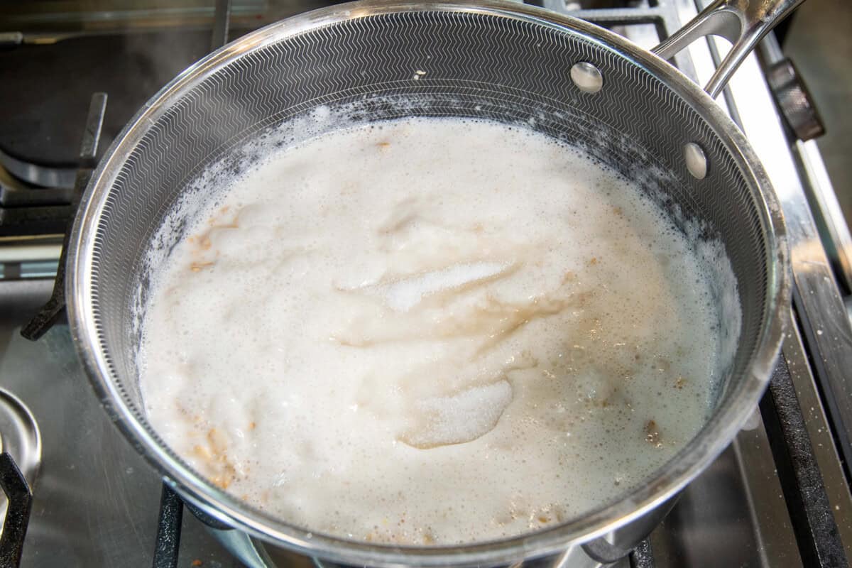 adding salt to the pot of oatmeal