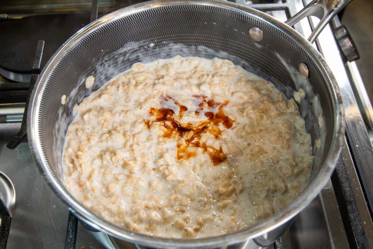 adding vanilla to the pot of sticky rice oatmeal