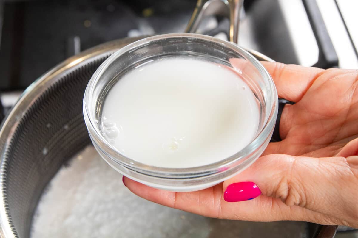 adding the cornstarch slurry to the sauce pan