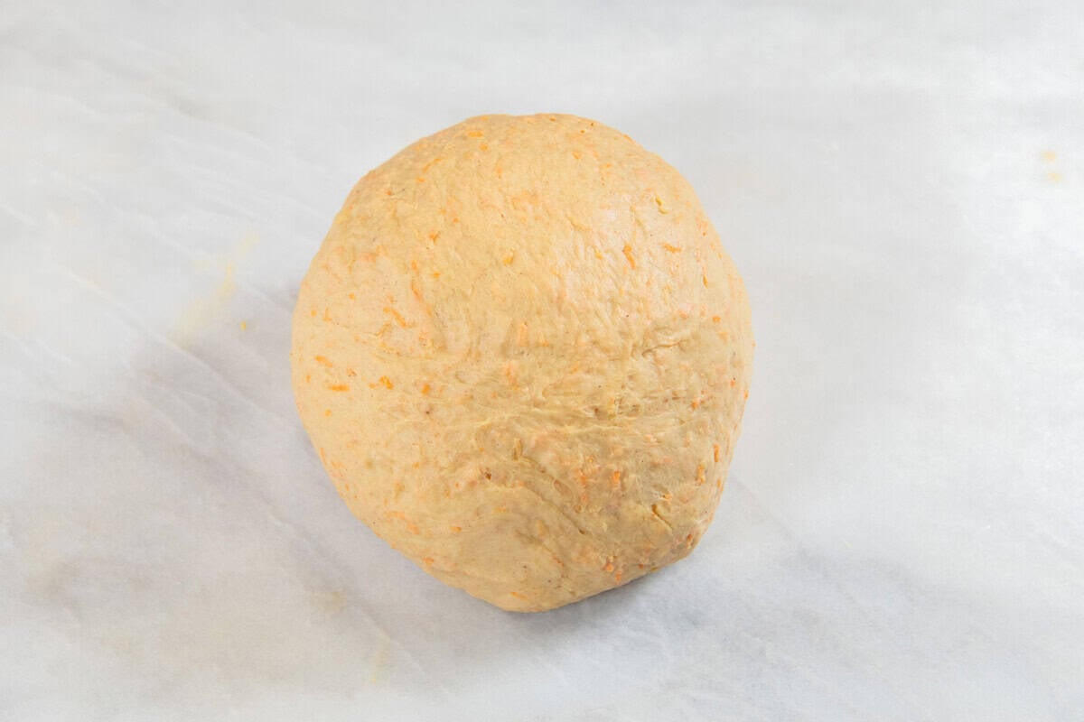 cinnamon roll dough on marble surface