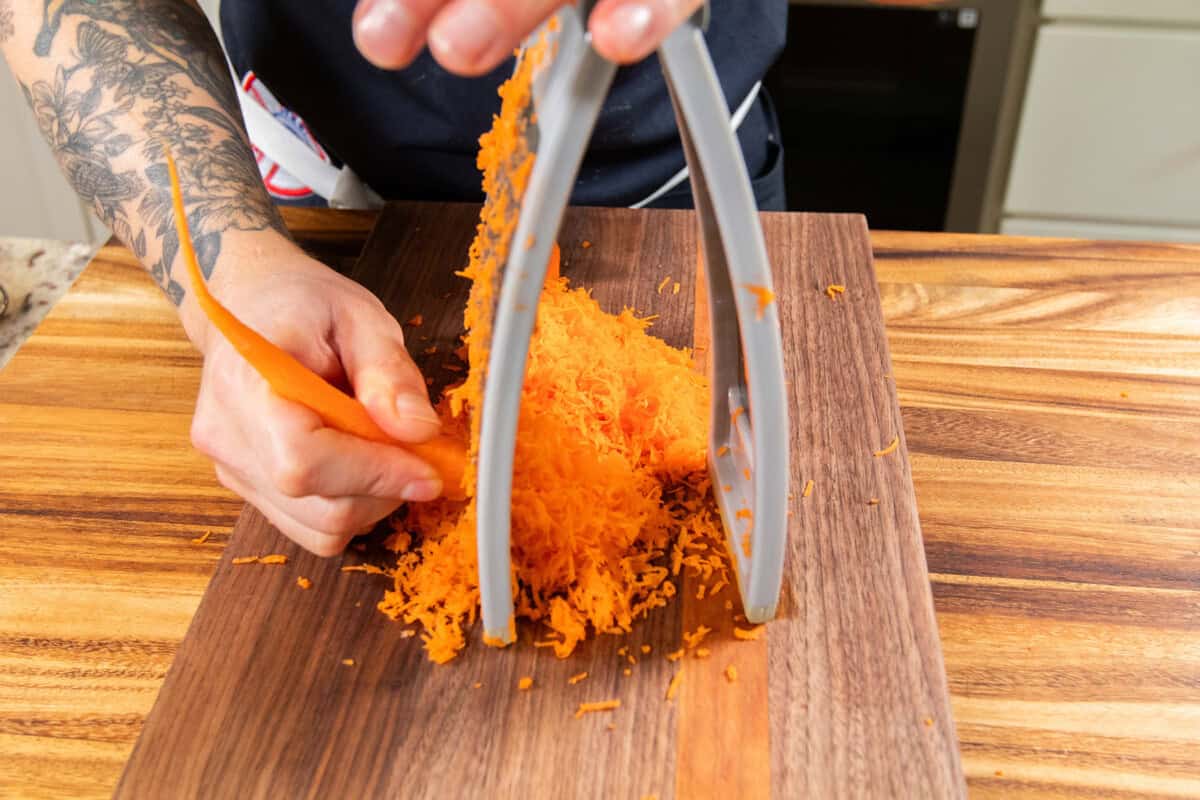 grating carrots on a cutting board