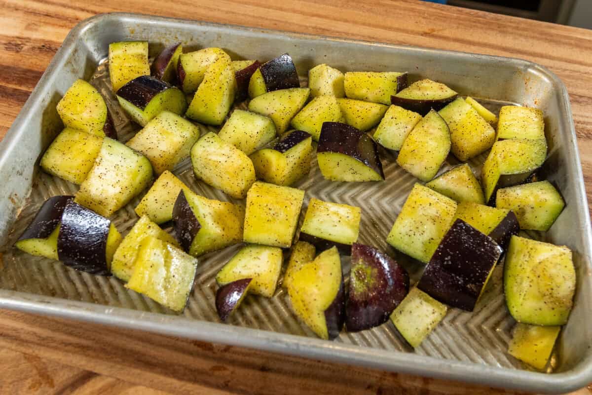 eggplant tossed with oil, salt and pepper on a baking sheet