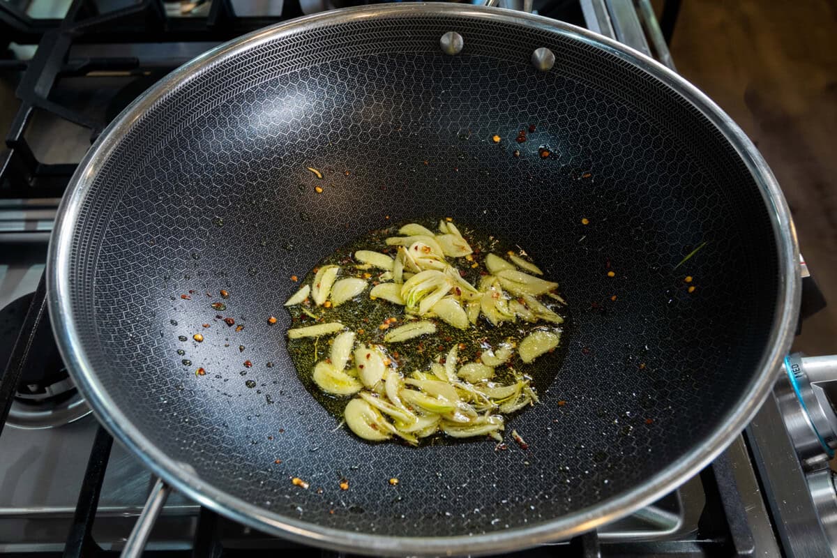 cooking sliced garlic and red pepper flakes in oil