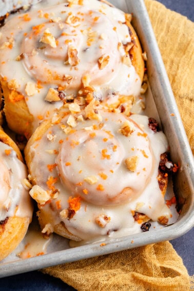 vegan carrot cake cinnamon rolls in baking sheet