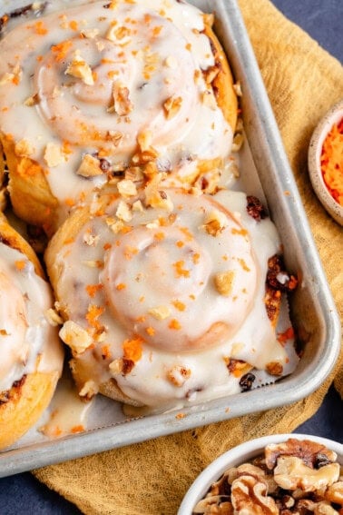 vegan carrot cake cinnamon rolls in baking sheet