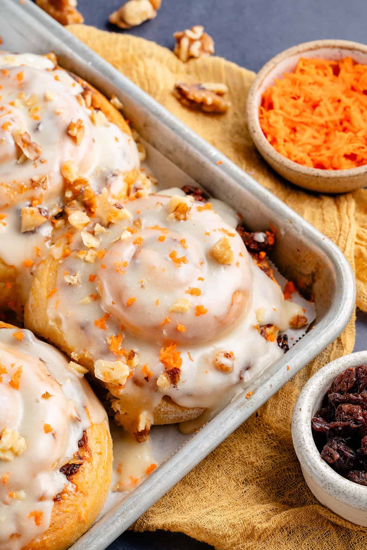 vegan carrot cake cinnamon rolls in baking sheet