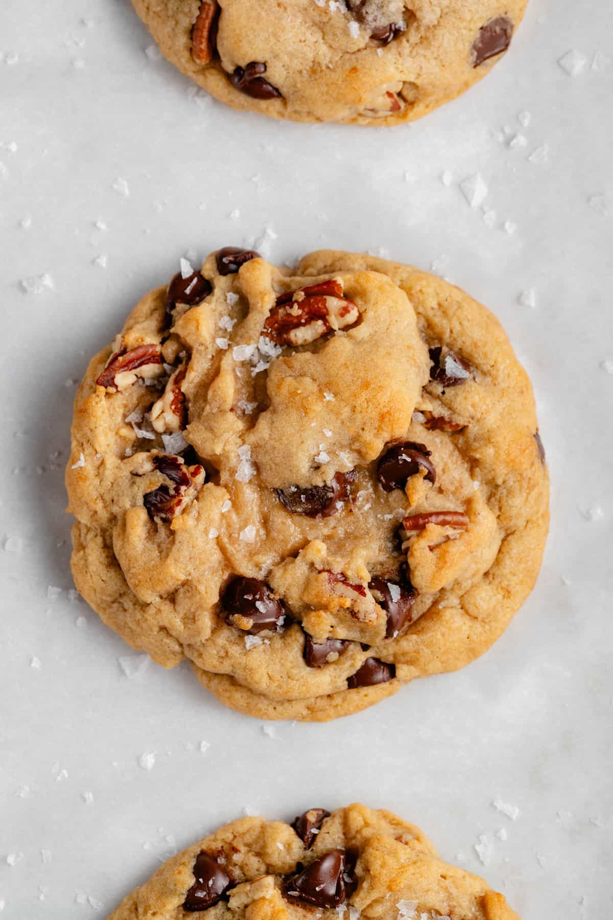 close up of Chunky Chocolate Chip Pecan Cookies on white background