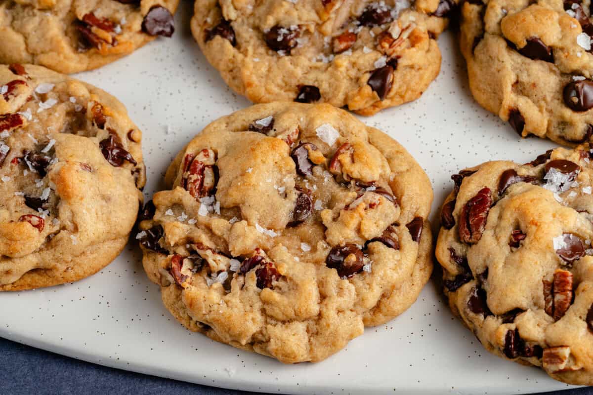 close up of Chunky Chocolate Chip Pecan Cookies on white platter