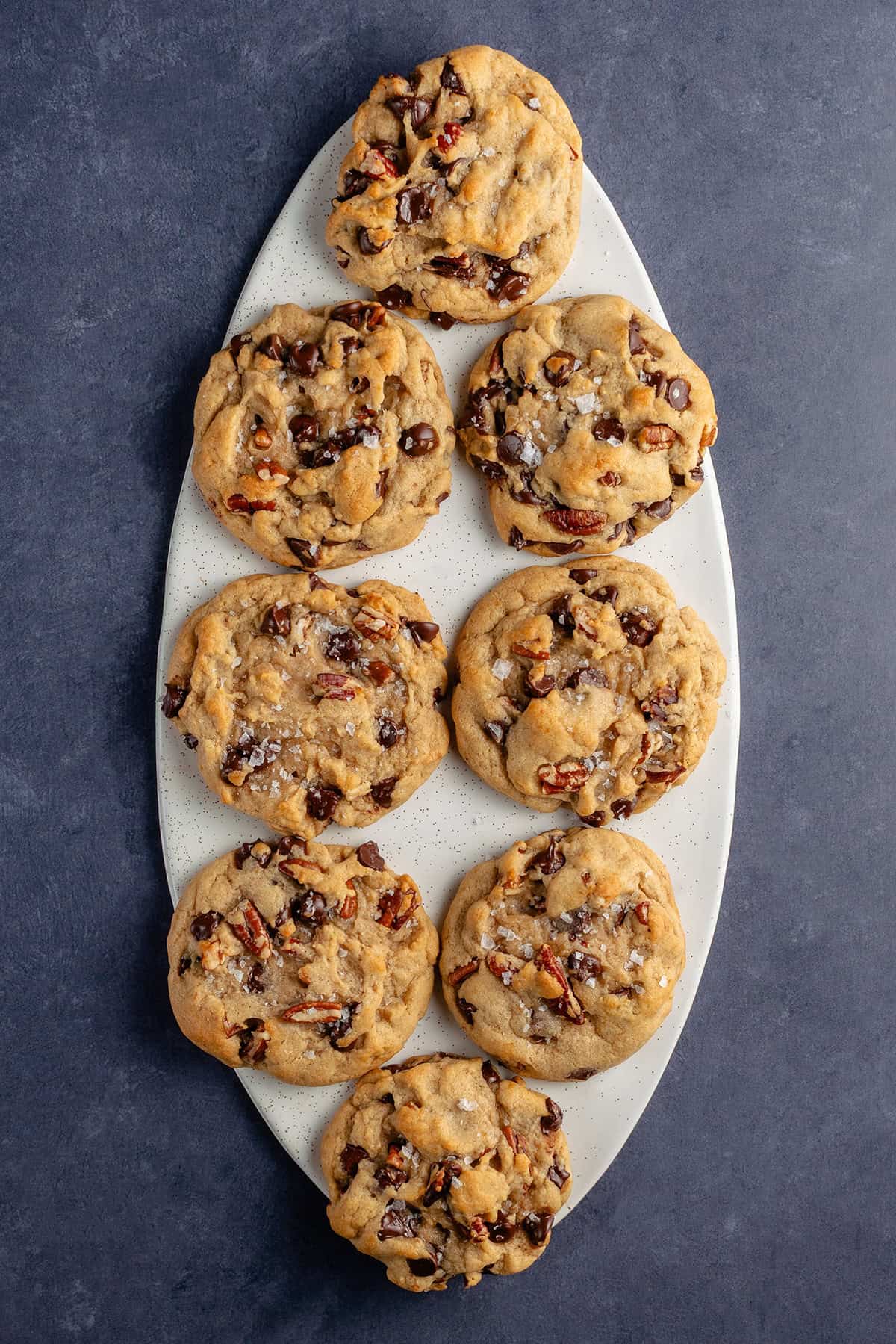 overhead of Chunky Chocolate Chip Pecan Cookies on white platter