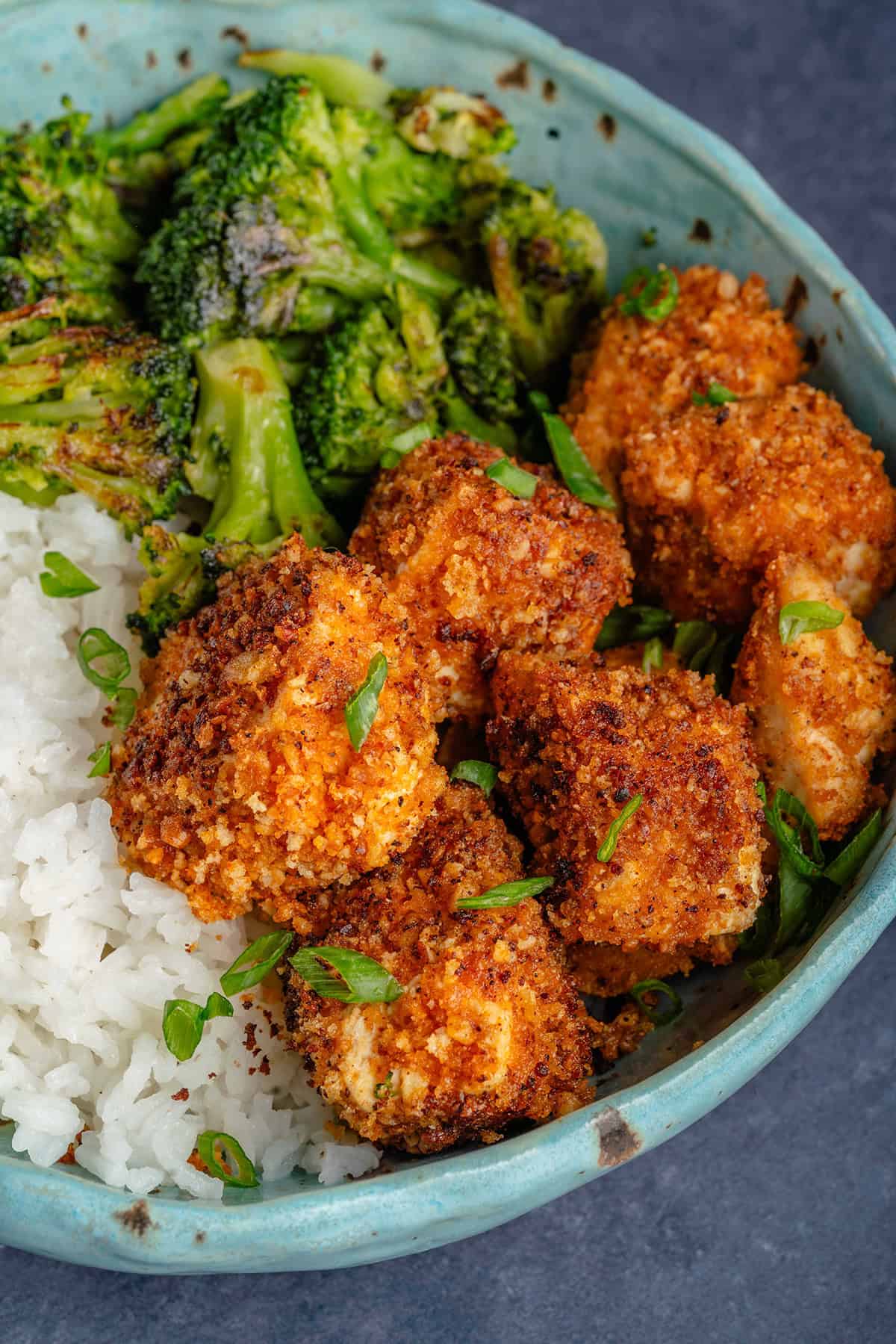 bowl of pecan crusted tofu with a side of rice and broccoli