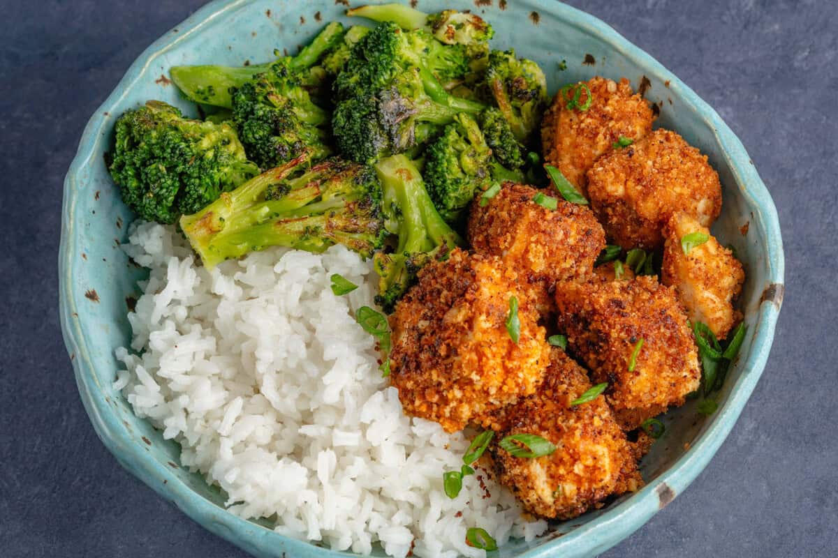 bowl of pecan crusted tofu with a side of rice and broccoli