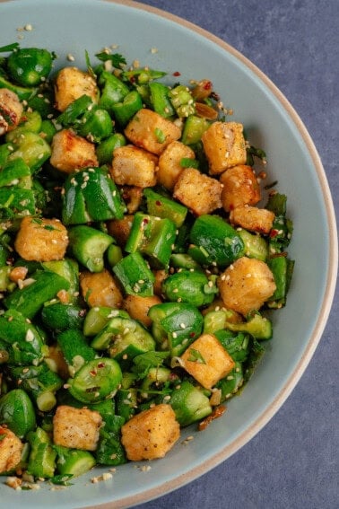 Smashed Cucumber Salad with Tofu in a bowl