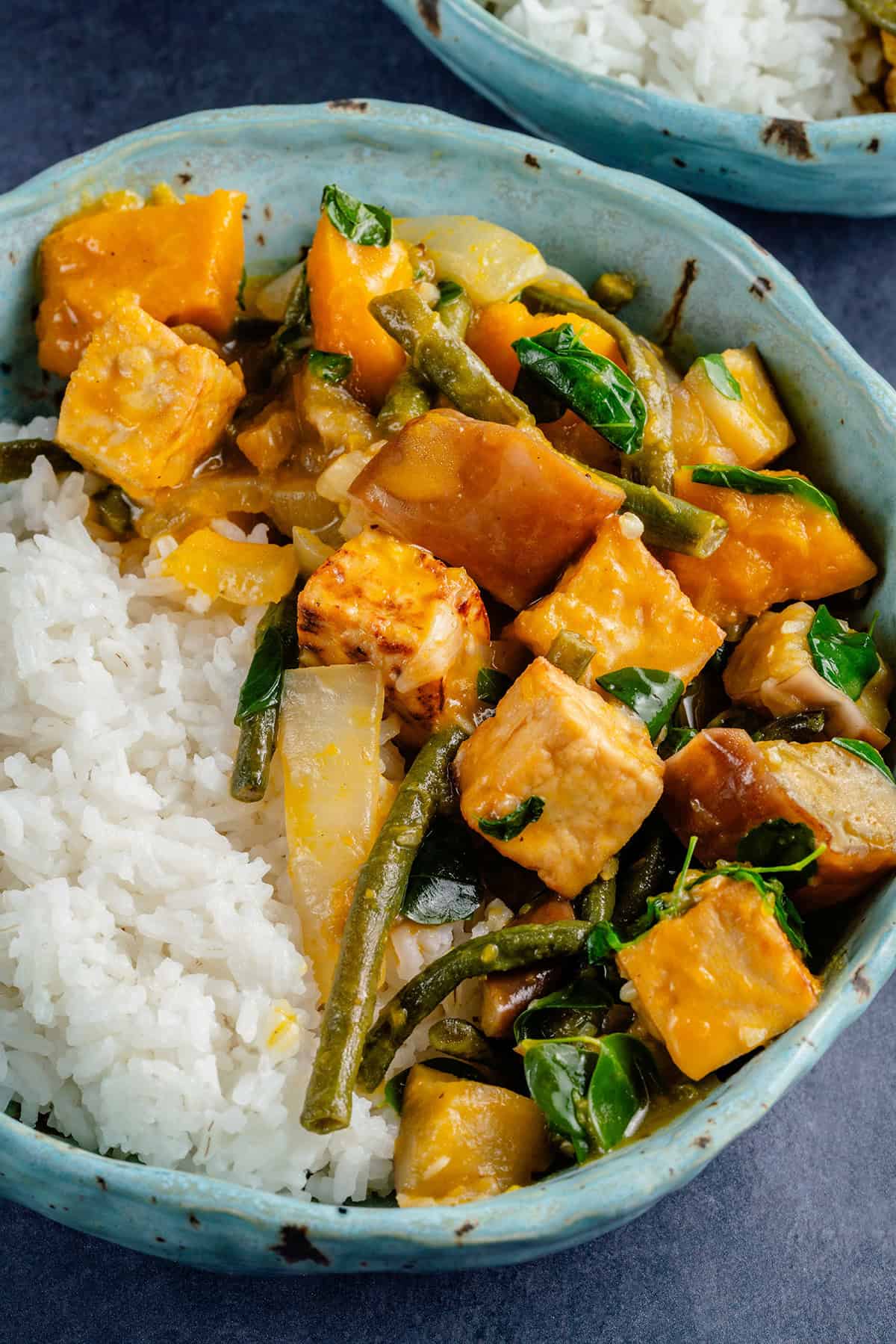 bowl of ginataang gulay with tofu and a side of rice