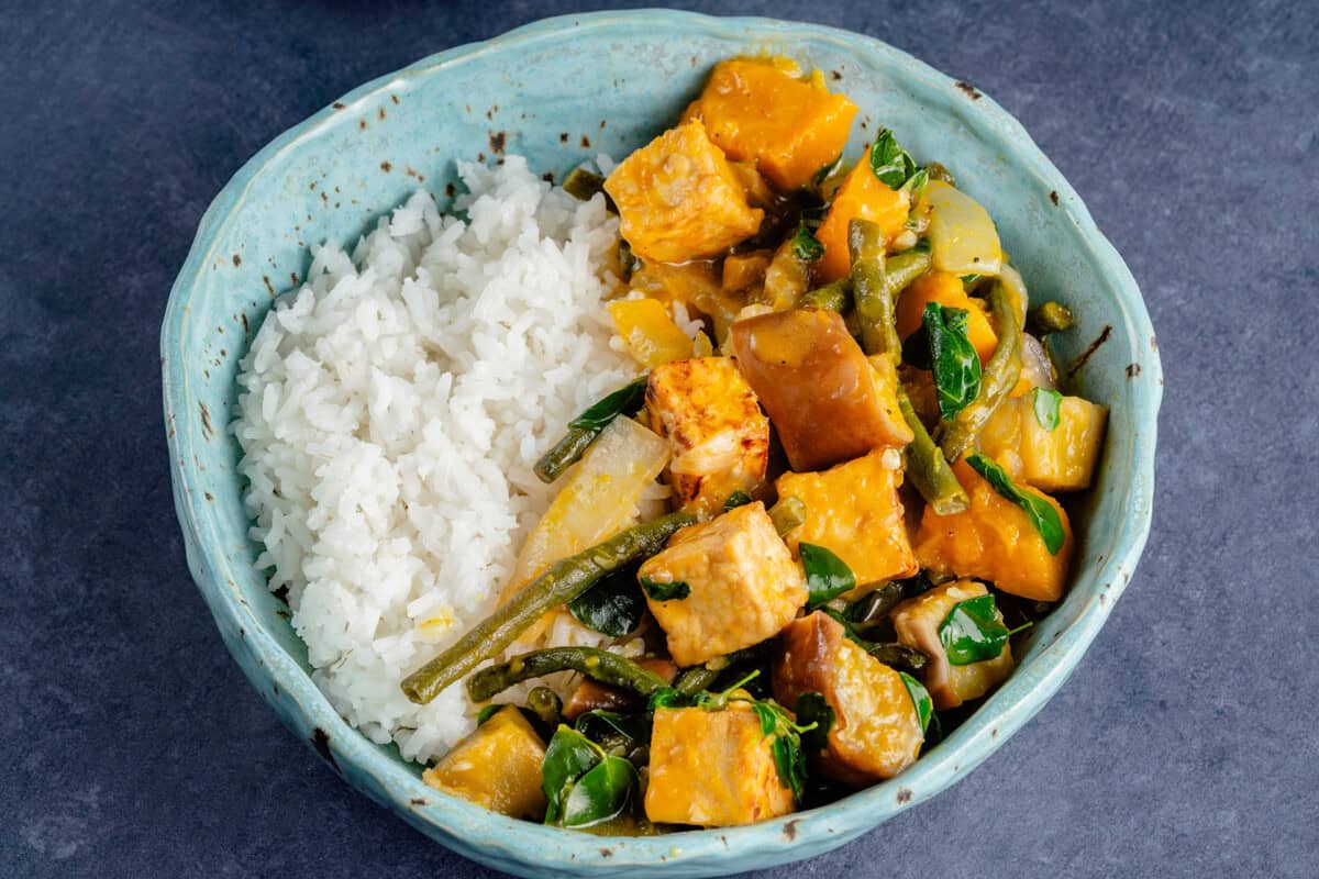 bowl of ginataang gulay with tofu and a side of rice