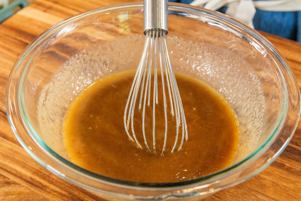whisked butter and sugar in a bowl with a whisk