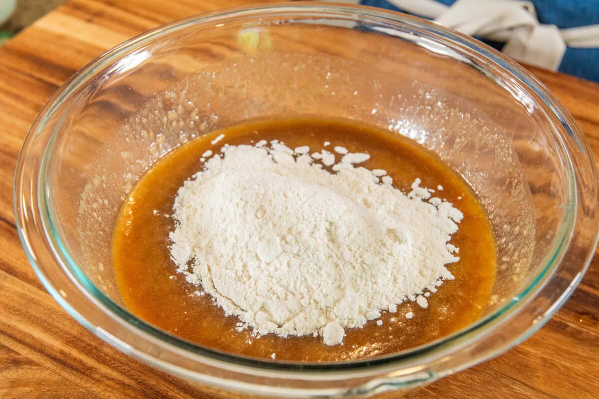 adding flour to the bowl