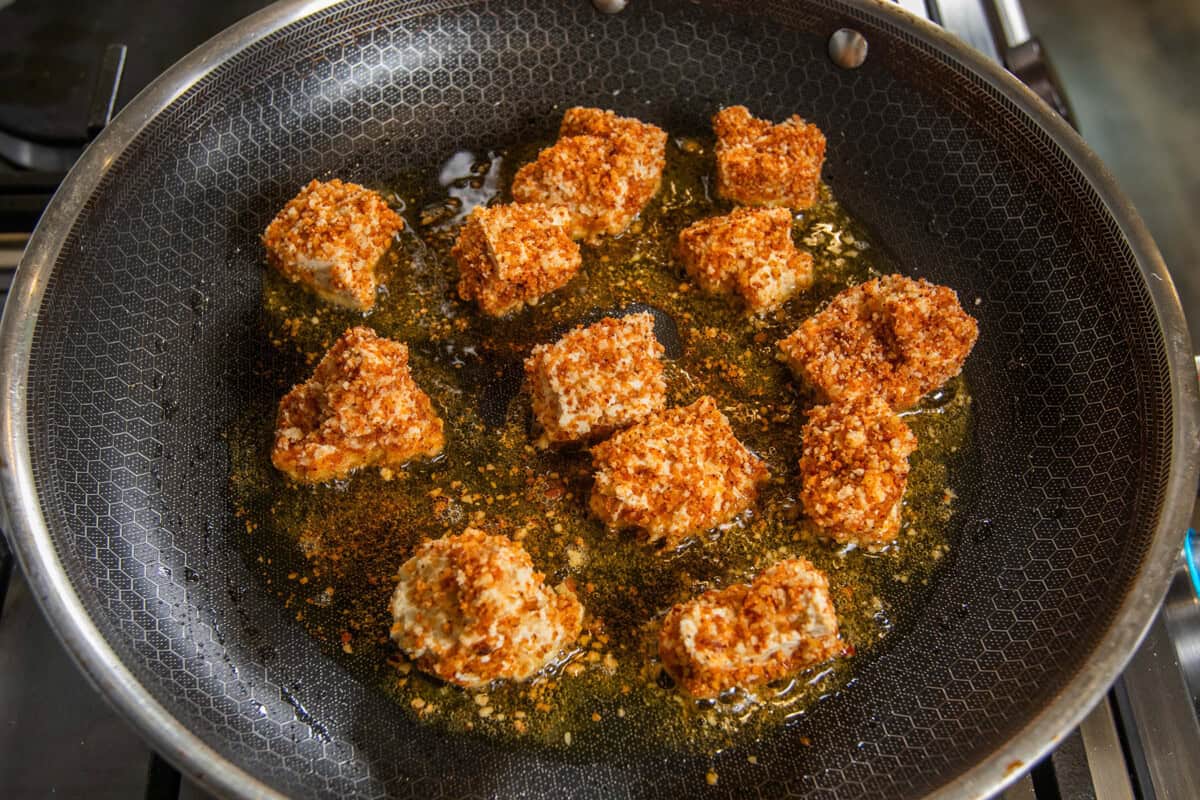 frying pecan crusted tofu in a skillet