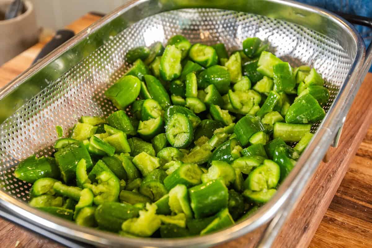chopped and smashed cucumbers in a strainer