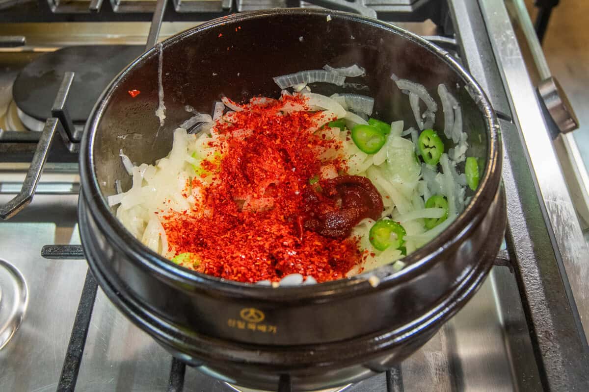 adding red pepper and gochujang to pot