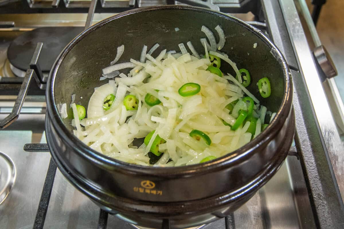 cooking onions and pepper in pot