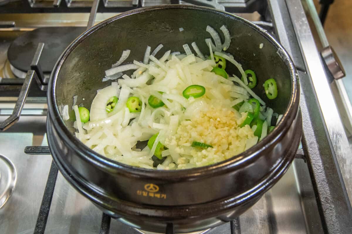 adding garlic to the pot