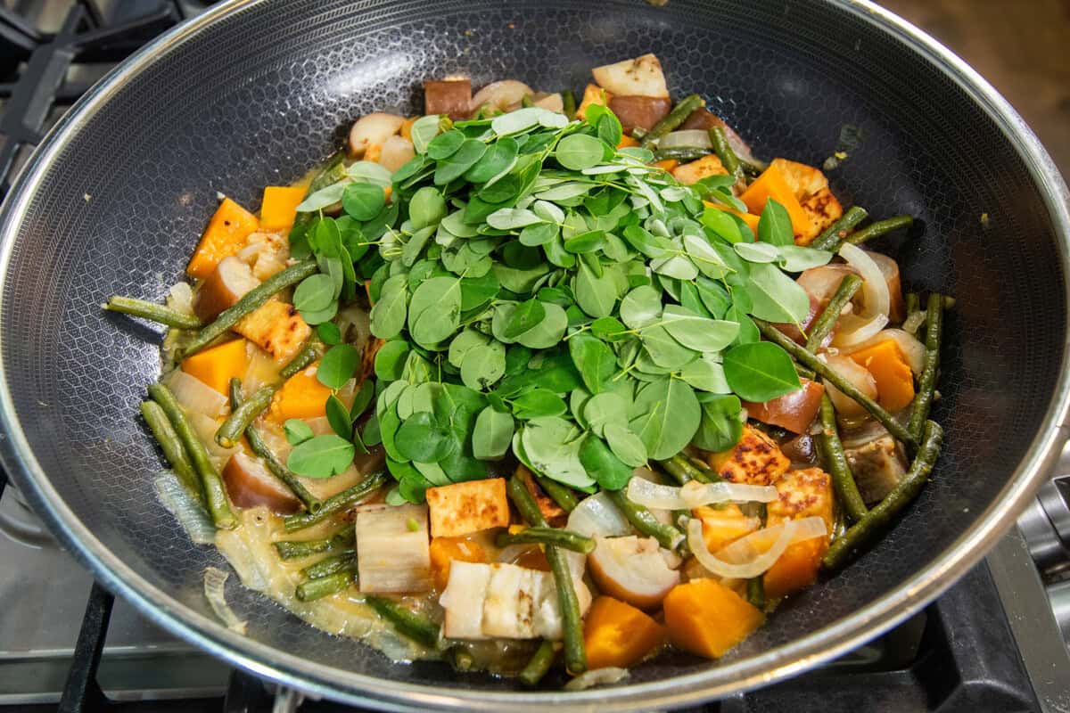 adding malunggay (moringa) to the pot