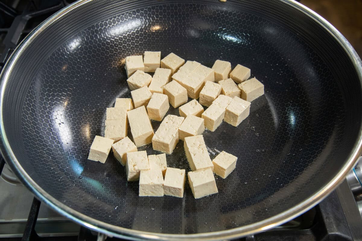 uncooked cubed tofu in large pan