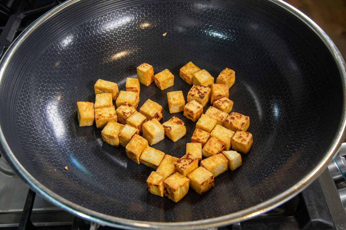cooked crispy cubed tofu in skillet