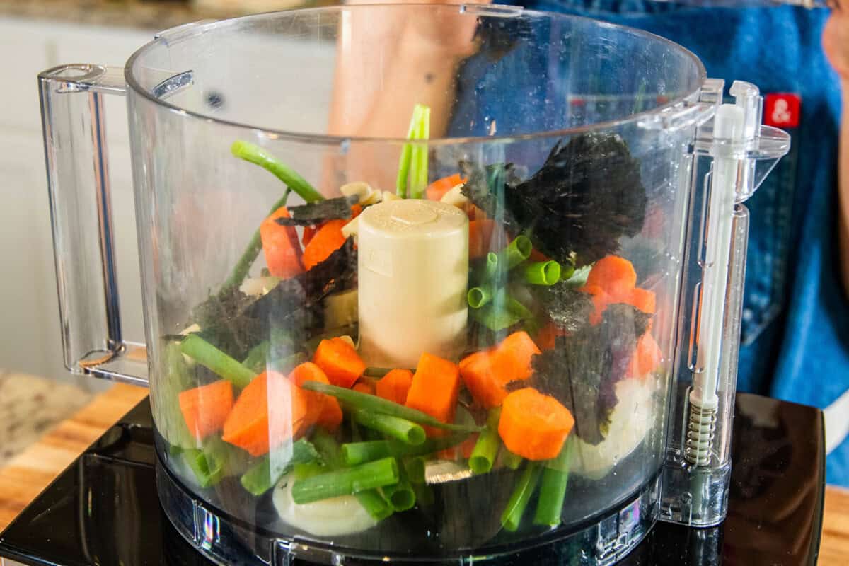 adding veggies to the food processor