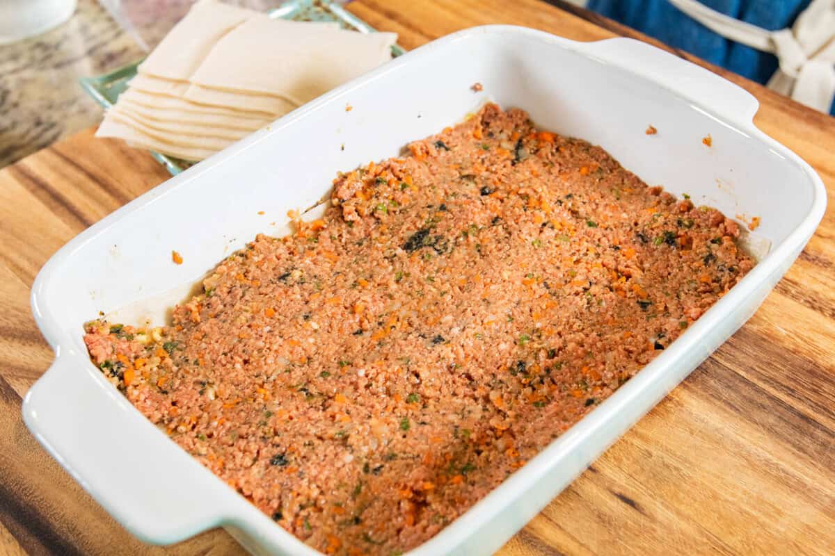 layer of lumpia filling in baking dish