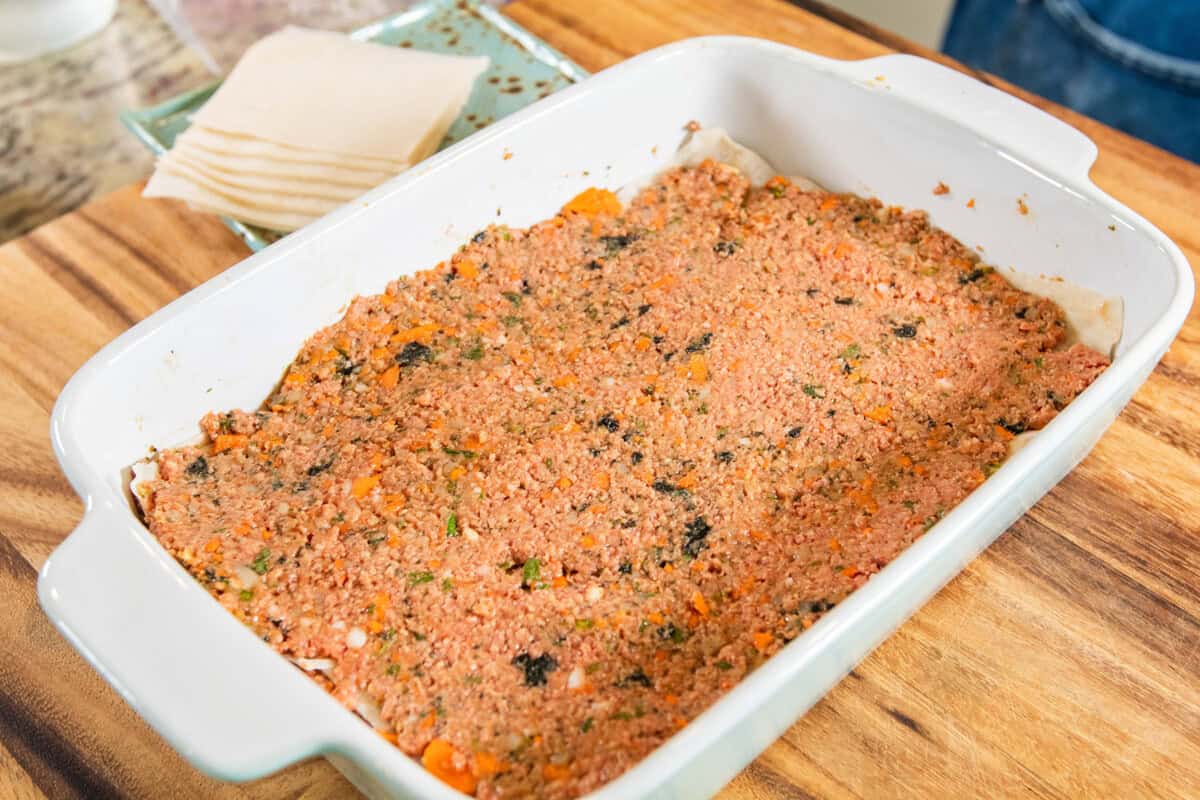 layer of lumpia filling in baking dish