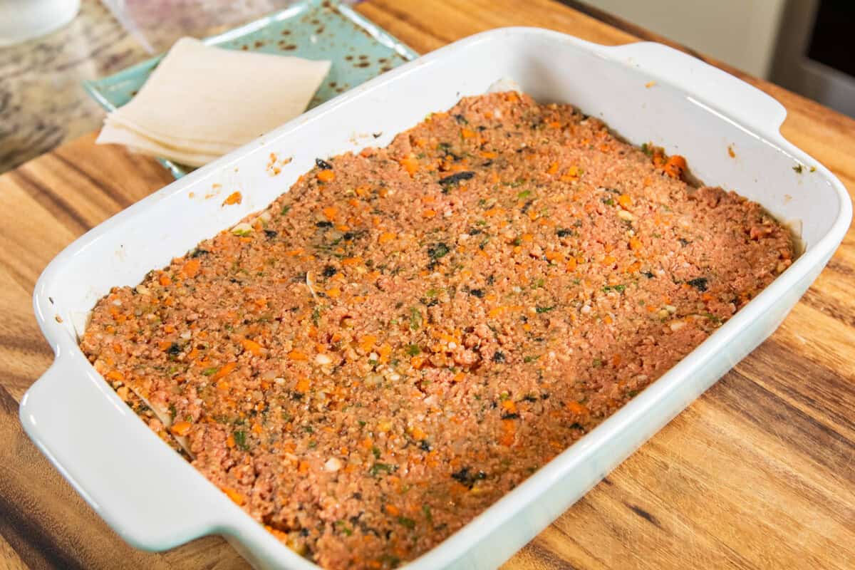 layer of lumpia filling in baking dish