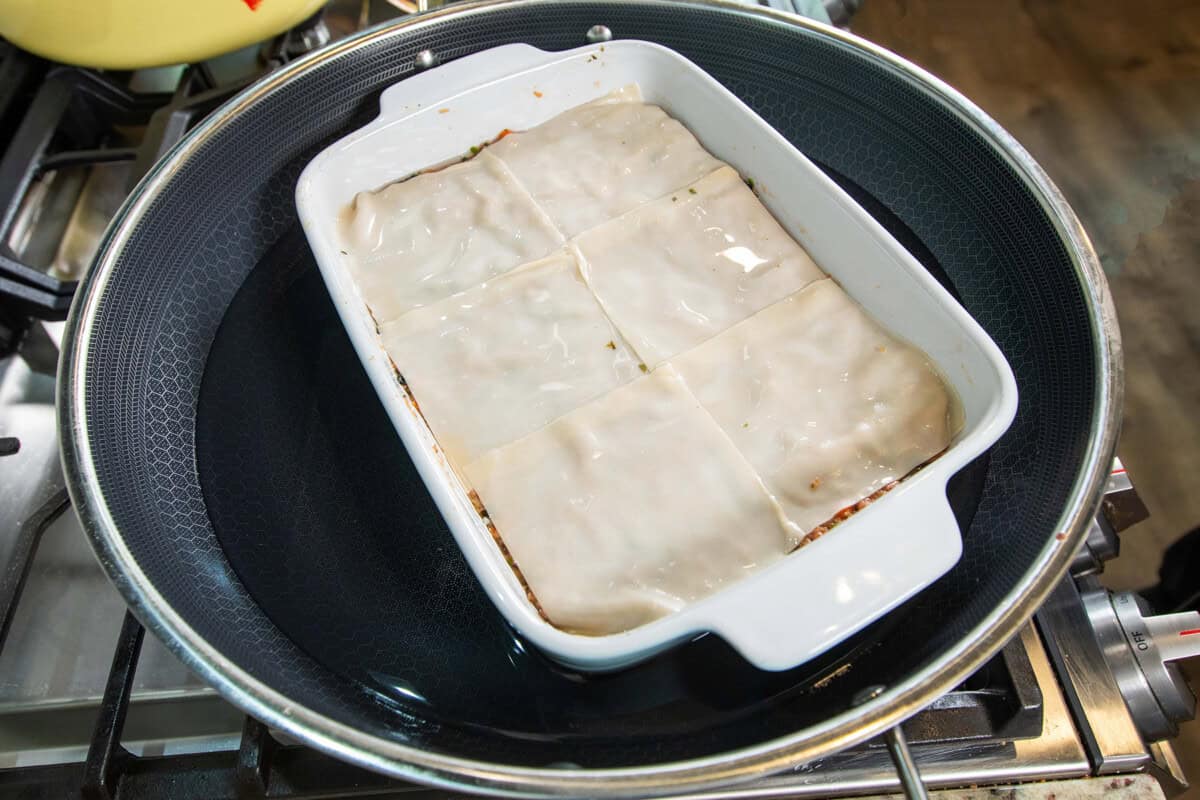 dumpling lasagna added to the pot to steam